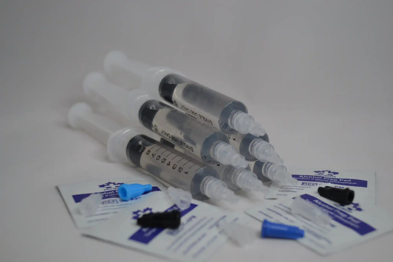 Medical syringes arranged together with some packaging materials.